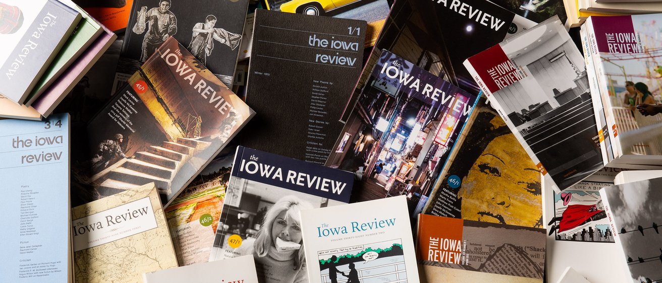 Several issues of Iowa Review magazine scattered on a table